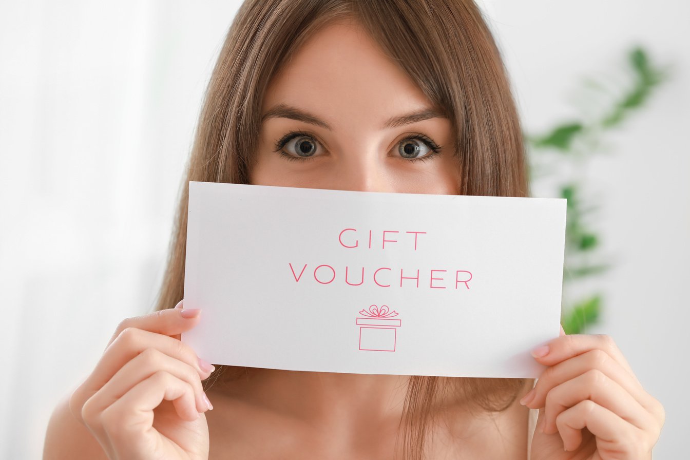 Beautiful Young Woman with Gift Voucher at Home